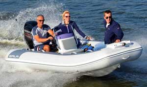 Crew boating in the bay on a 12ft Gala aluminum rigid inflatable boat (RIB) equipped with a Mercury outboard motor.
