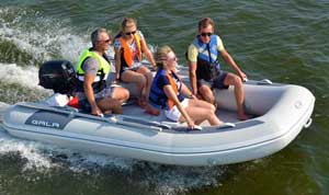 Family boating at sea in a Gala 12ft foldable inflatable boat dinghy equipped with a 30HP Yamaha outboard engine.
