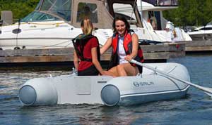 Ladies rowing a Gala 8ft foldable inflatable dinghy in the marina.