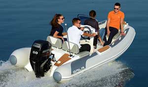 Crew riding in open water on an 14ft aluminum Gala rigid inflatable boat (RIB) equipped with a fiberglass steering console & 60HP Mercury outboard motor.