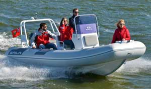 Boating crew on Lake Ontario in a Gala 19ft aluminum rigid inflatable boat (RIB) rigged with steering console, seating, arch, and Yamaha outboard motor.